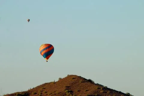 Hot Air Balloons over Desert Mountain Stock Photos