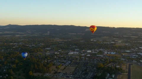 Hot air balloons over small town Stock Footage 56433799