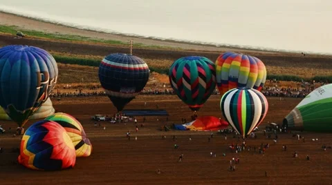 Hot air balloons take off at sunrise aerial timelapse Stock Footage