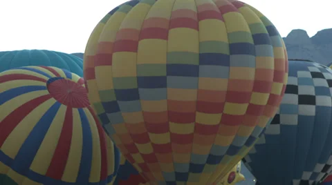 Hot air balloons taking off in front of the sandias in nm Stock Footage 35990784