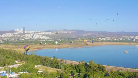 Hot Air Baloons Flying Over the Lake Stock Footage 321566124