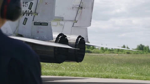 Hot air flows out of the jet fighter's turbine. Shooting on the runway. Stock Footage 155211707
