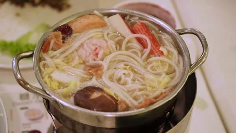Hot and flavourful noodle soup with fresh ingredients served in a pot 動画素材 317371353