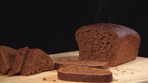 Hot and fresh bread. Steam comes out. Handmade black bread on black background.  Stock Footage 72250200