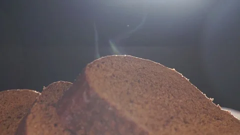 Hot and fresh bread. Steam comes out. Handmade black bread on black background. Stockbeeldmateriaal 72250280