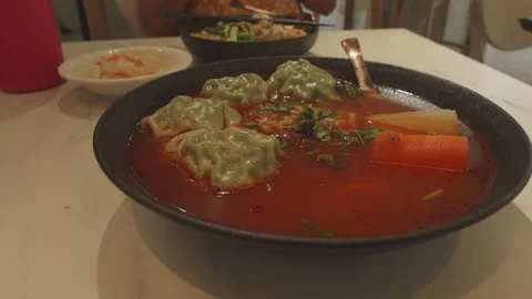 Hot and Sour Dumpling Soup served at Restaurant, Medium shot Видео 344563589