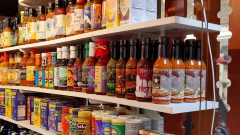 Hot and Spicy: A Sample of Reading Terminal Market's Hot Sauce Selection Vídeo Stock 232075529