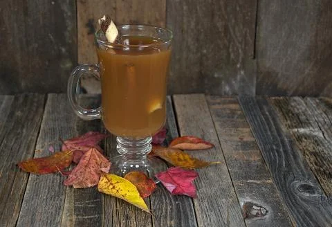 Hot apple cider with fall leaves Stock Photos