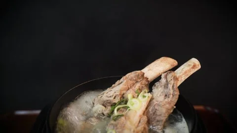 Hot Beef Short Rib Soup Bubbling in Korean Ttukbaegi Stock Footage 335256909