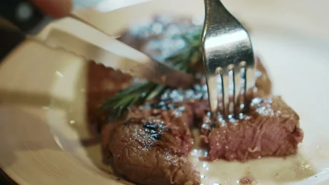 Hot beef steak is being cut by the client of expensive restaurant, close up. Stock Footage 87323029