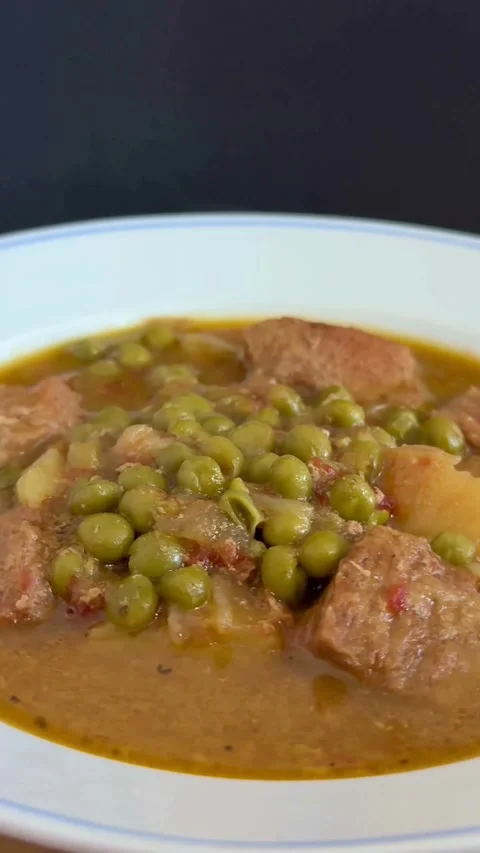 Hot beef stew with green peas and potatoes steaming Stock Footage 331974837