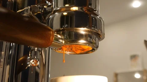 Hot beverage drips through bottomless filter of modern coffee machine into cup Stock Footage 94513642