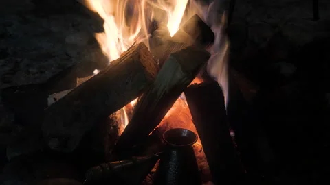 Hot beverage prepared in coffeemaker on campfire embers Stock Footage 213978641