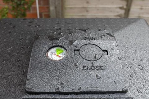 Hot bin compost bin lid temperature gauge and vent urban backyard organic garden Stock Photos