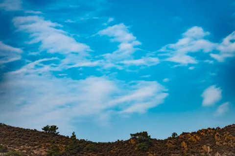 Hot blue sky with white clouds. Stock Photos