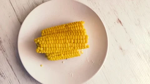 Hot, boiled corn sprinkled with salt. Stock Footage 134705671
