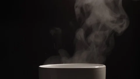 Hot boiled water is poured with splashes into a white ceramic cup Stock-Footage 129709723