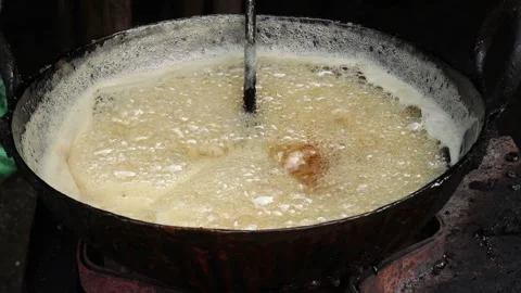 Hot Boiling Dark Brown Sugar Sweet Sugar And Jaggery Syrup With Bubbles Stock Footage 166179241