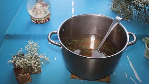 Hot boiling liquid soup close-up on blue background, slider shot Stock Footage 101309119
