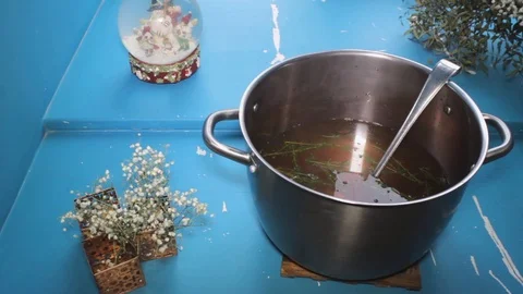 Hot boiling liquid soup close-up on blue background, slow slider shot Stock Footage 101309142