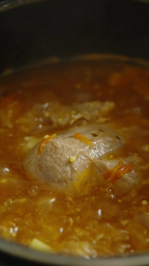 Hot boiling stew meat soup with bubbles close up cooking Stock-Footage 338273657