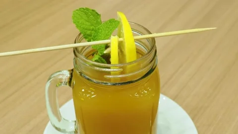 Hot buckthorn drink with mint leaf and fruit slices Stock Footage 144306709