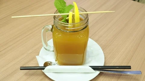 Hot buckthorn drink with mint leaf and fruit slices Stock Footage 144306735