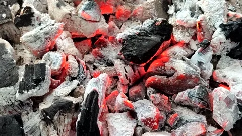 Hot burning charcoal with red embers and white ash Stockbeeldmateriaal 336877271