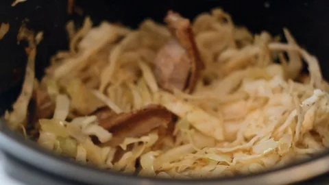 Hot cabbage fried with meat in multikocher Stock Footage 87797406