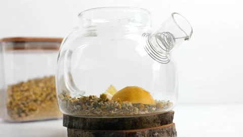 Hot chamomile tea pot with lemon Stock Footage 148328233