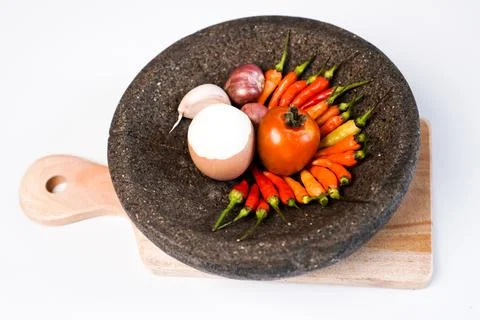Hot chili paste alongside a single partially peeled hard-boiled egg, neatly.. Stock Photos