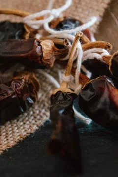 Hot chilli pepper on black background with rustic cloth, vintage tablecloth.  Stock Photos