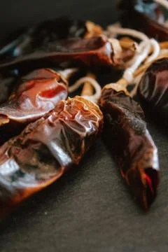 Hot chilli pepper on black background with rustic cloth, vintage tablecloth.  Stock Photos