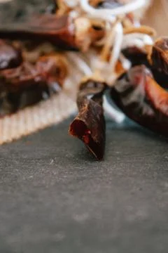 Hot chilli pepper on black background with rustic cloth, vintage tablecloth.  Stock Photos