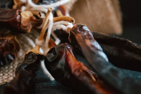Hot chilli pepper on black background with rustic cloth, vintage tablecloth.  Stock Photos