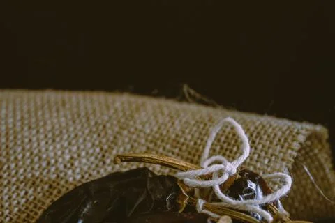 Hot chilli pepper on black background with rustic cloth, vintage tablecloth.  Stock Photos