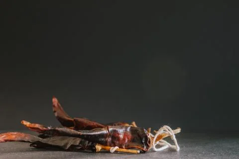 Hot chilli pepper on black background with rustic cloth, vintage tablecloth.  Stock Photos