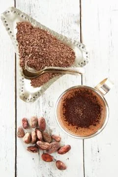 Hot chocolate, cocoa beans and grated chocolate on white wooden Stock Photos