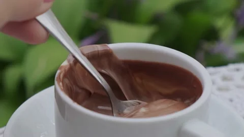 Hot chocolate cup on table at cafe outdoors summer. Coffee time and breakfast in Stock Footage 163692480