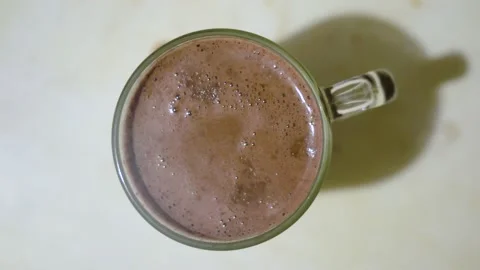 Hot chocolate cup on table. Chocolate, hot frothed milk, cocoa. Rotation Stock Footage 167087490