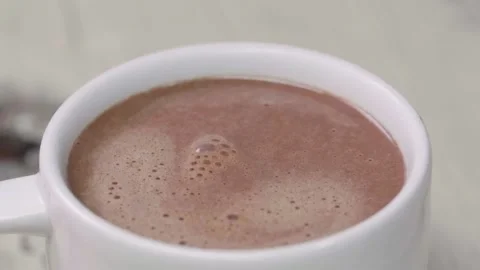Hot chocolate drip into mug Stock Footage 166863241