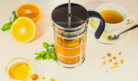 Hot citrus tea with lemon, fresh mint and fruit. Tea party with fruit in the  Stock Photos