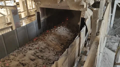 Hot Clinker Falling from Cooler to Conveyor Belt in Cement Plant 4K Stock Footage 333338952