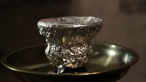 The hot coal is placed on the hookah Stock-Footage 82730671