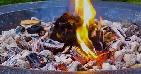 Hot coals glowing in a fire pit on a warm summer evening Stock-Footage 91839388