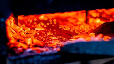 Hot coals in the grill, background, glowing coals in the background, mid view Stock Photos