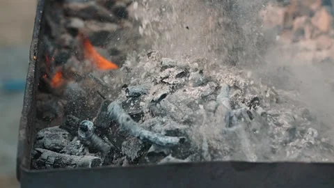 Hot coals smolder under a thin layer of ash Stock Footage 344873306