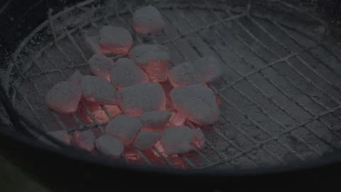 Hot coals/charcoal glowing red  glowing on a Barbecue Stock Footage