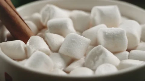 Hot cocoa with marshmallows, cinnamon in a white mug with patterns, surrounde Stock Footage 144065025