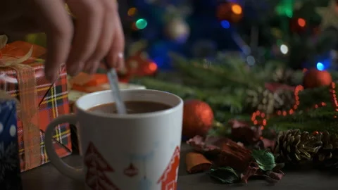 Hot cocoa surrounded by winter Christmas tree on a wooden table. Concept of a Stock Footage 165437531